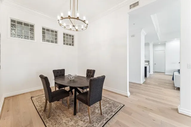 a view of a dining room with furniture wooden floor and chandelier