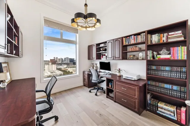 a view of a workspace with furniture and a bookshelf