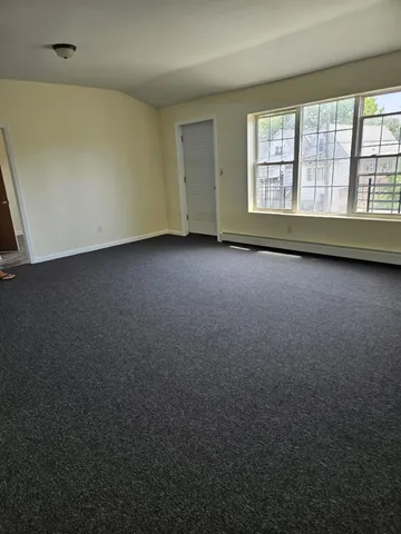 an empty room with a empty space and windows