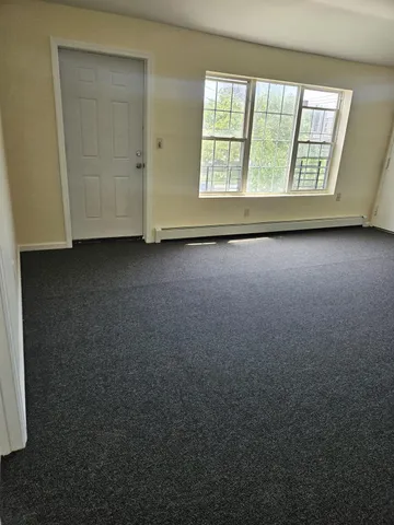 an empty room with a empty space and windows