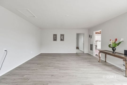 420 West Upjohn Avenue Ridgecrest, CA 93555 - Photo 19 of 32 a view of empty room with wooden floor and a window