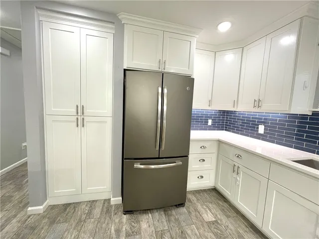 a kitchen with a refrigerator and a sink