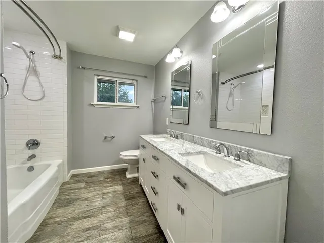 a spacious bathroom with a granite countertop sink and a mirror