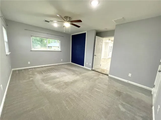 an empty room with windows and closet