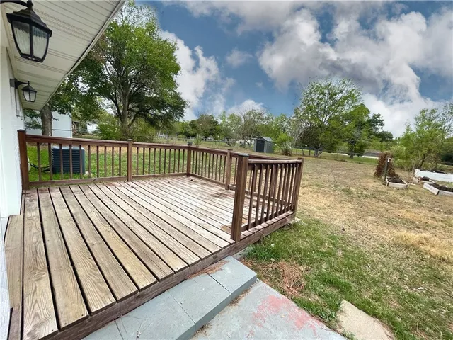 a view of balcony with wooden floor and fence