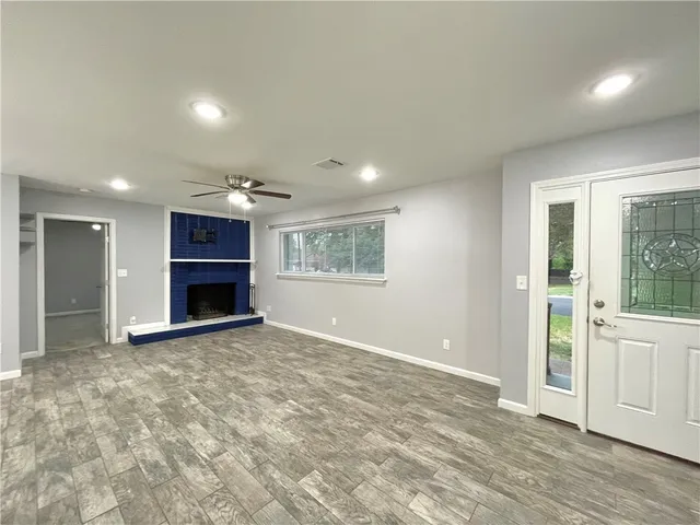 an empty room with a fireplace and window