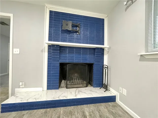 a living room with a fireplace and a fireplace