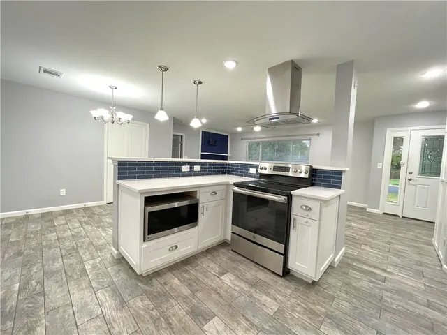 a kitchen with stainless steel appliances granite countertop a stove and a sink