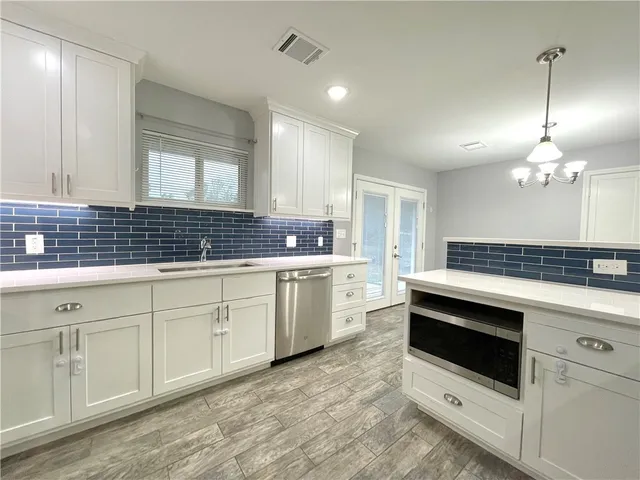 a kitchen that has a sink and cabinets
