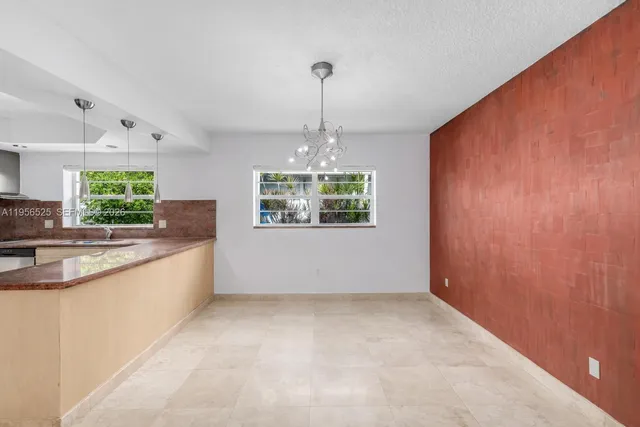 a kitchen with stainless steel appliances granite countertop a sink and cabinets