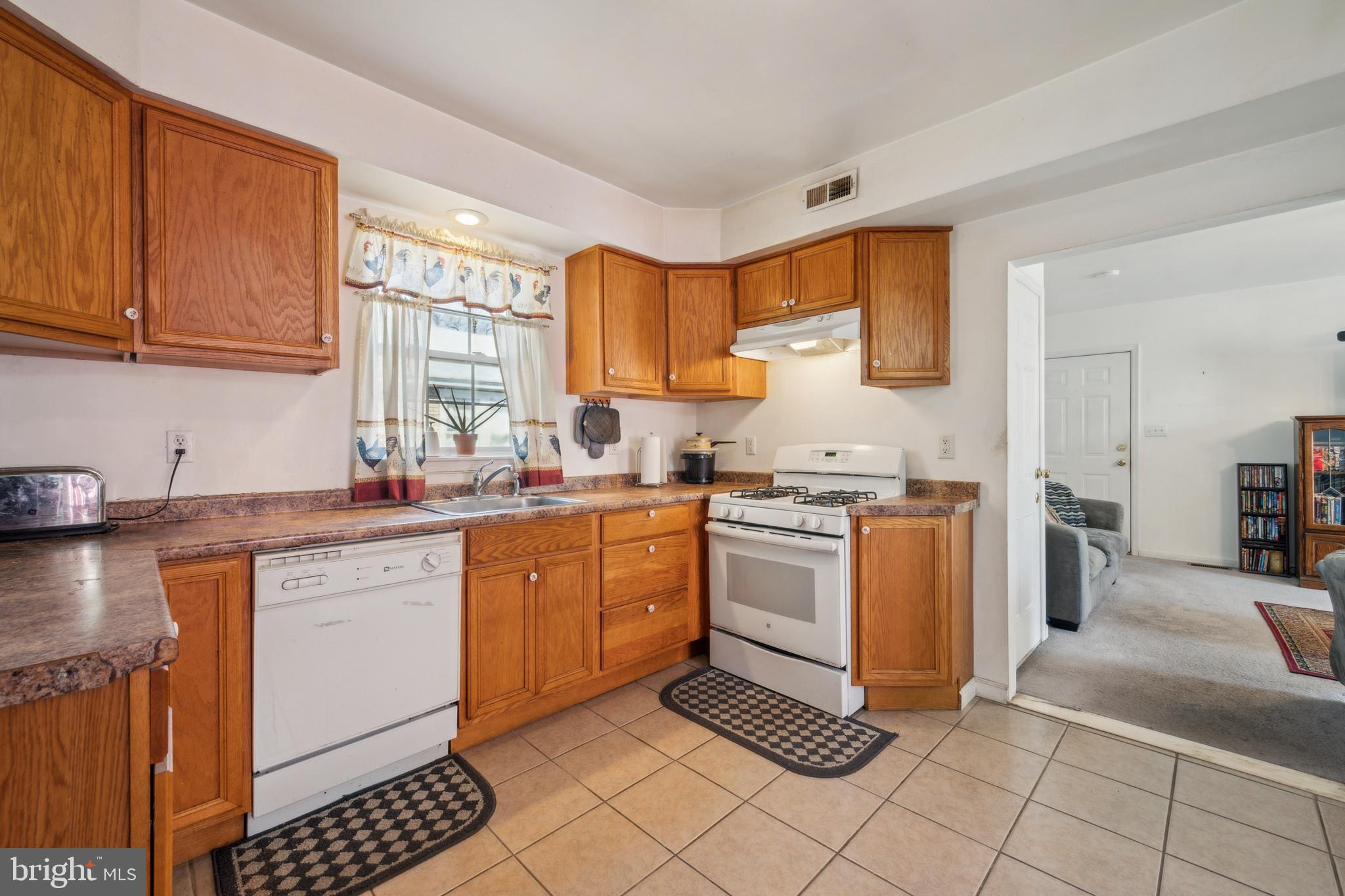 19 Stewart Avenue Delran, NJ 08075 - Photo 12 of 25 a kitchen with granite countertop a stove sink and cabinets