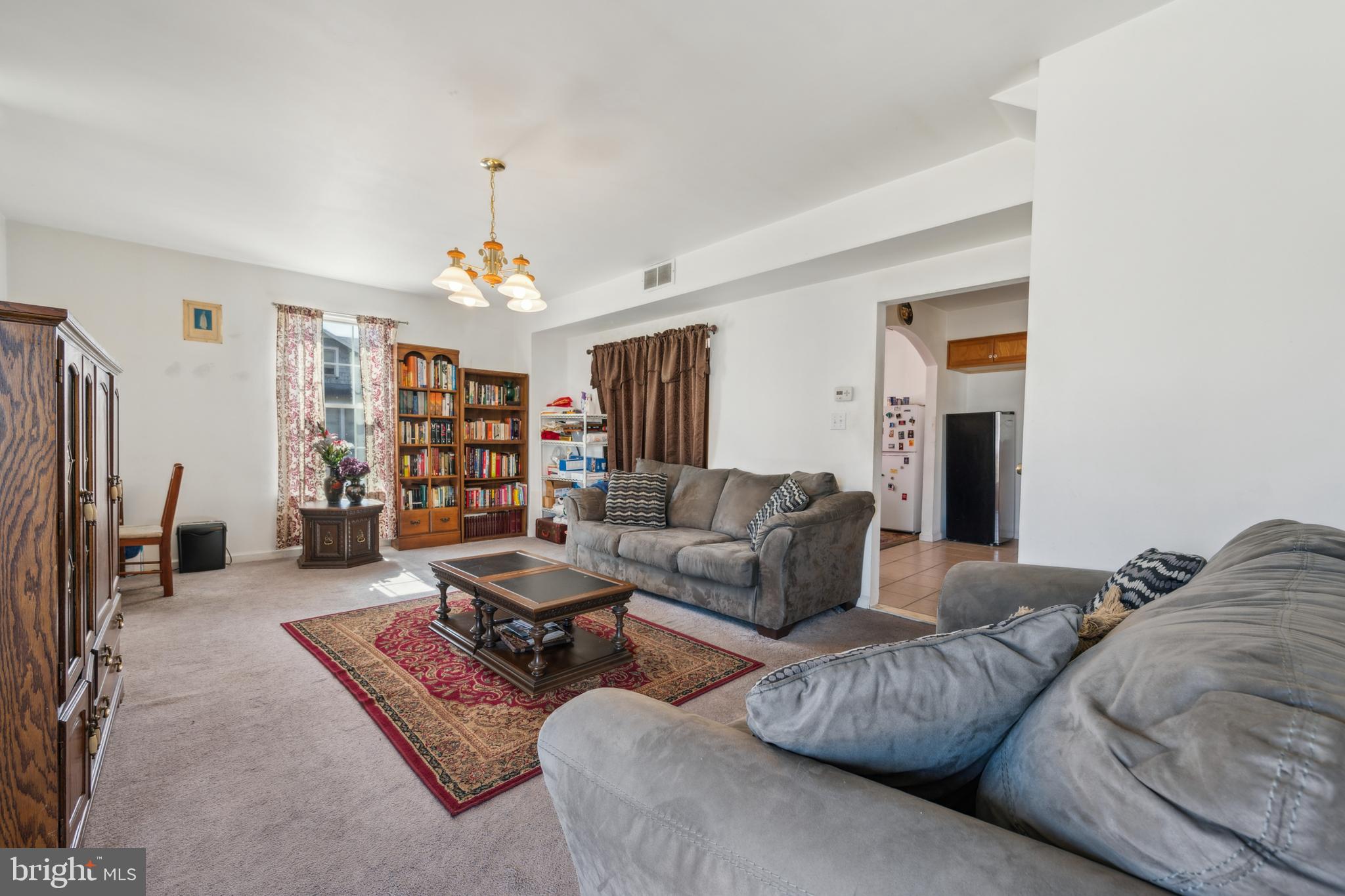 19 Stewart Avenue Delran, NJ 08075 - Photo 6 of 25 a living room with furniture a rug and a chandelier