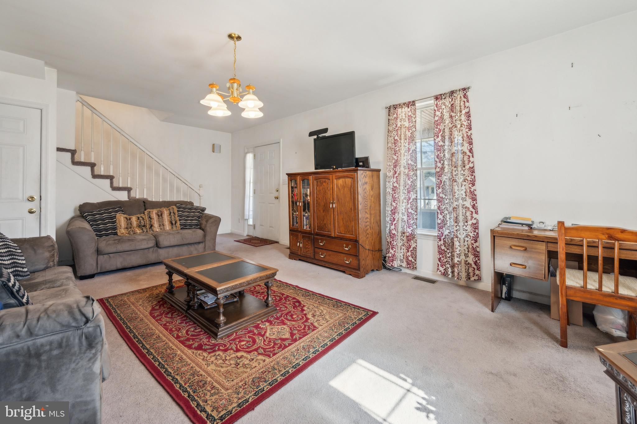 19 Stewart Avenue Delran, NJ 08075 - Photo 8 of 25 a living room with furniture and a chandelier