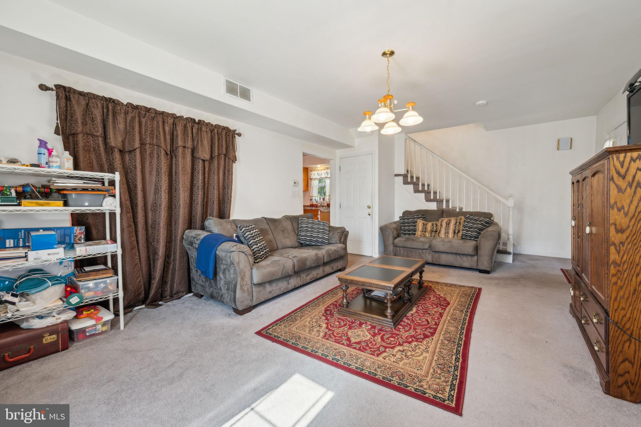 19 Stewart Avenue Delran, NJ 08075 - Photo 9 of 25 a living room with furniture a fireplace and a chandelier
