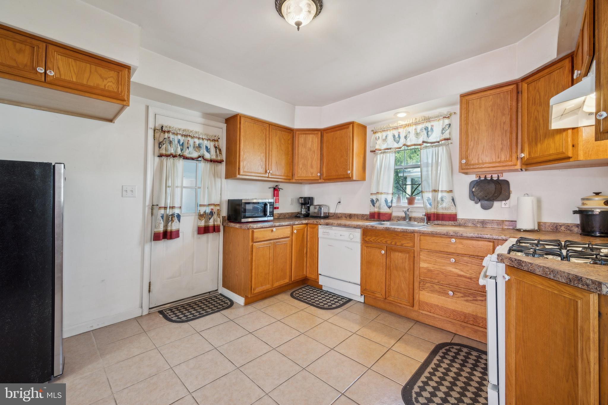 19 Stewart Avenue Delran, NJ 08075 - Photo 10 of 25 a kitchen with stainless steel appliances granite countertop a stove a sink and a refrigerator