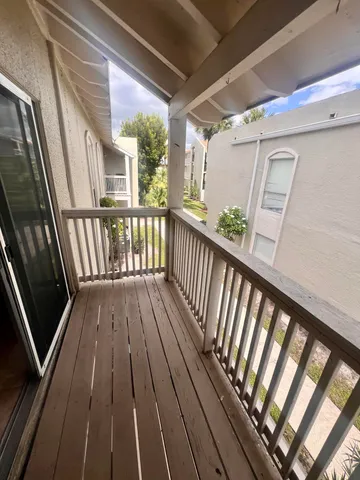 a front view of multi story residential apartment building with yard and green space