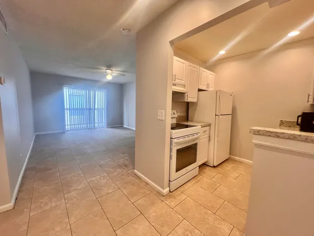 a kitchen with a sink a stove top oven and cabinets