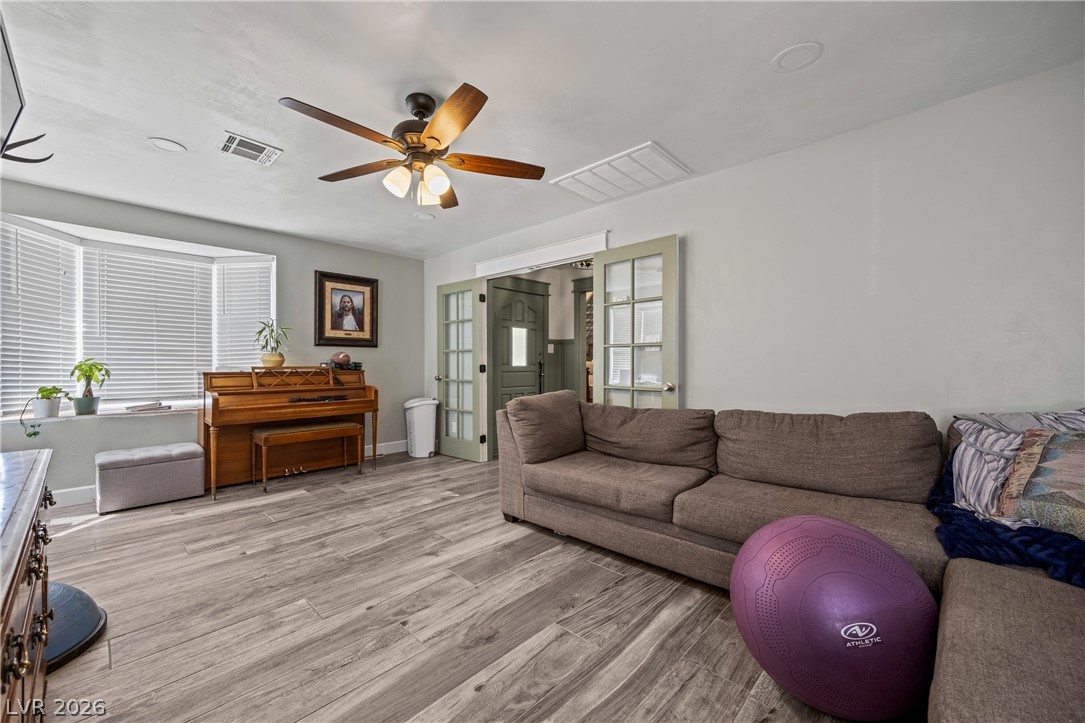 750 Leming Avenue Overton, NV 89040 - Photo 18 of 82 This inviting living space features warm flooring, a charming bay window, and elegant French doors.
