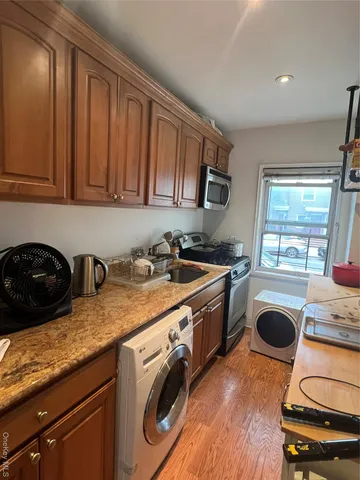 a kitchen with stainless steel appliances granite countertop a stove a sink and a microwave