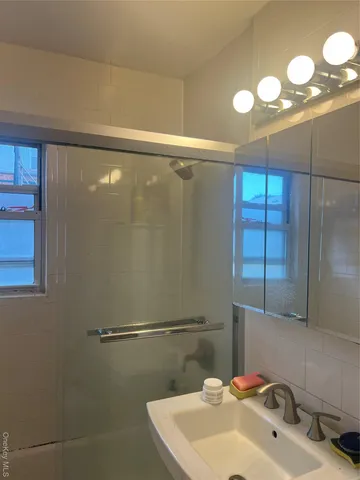 a bathroom with a sink and mirror