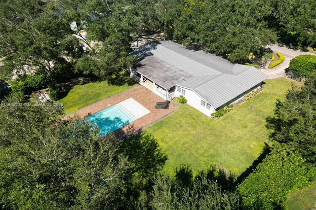 an aerial view of houses with yard