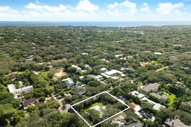 an aerial view of residential houses with city view