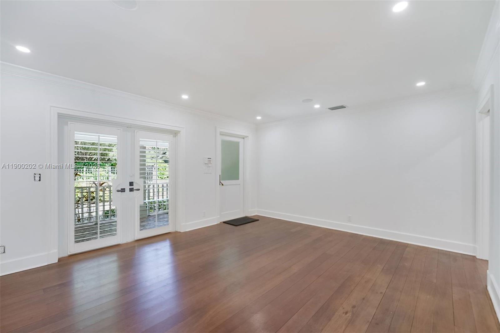 4920 Southwest 76th Street Miami, FL 33143 - Photo 18 of 36 a view of an empty room with wooden floor and a window
