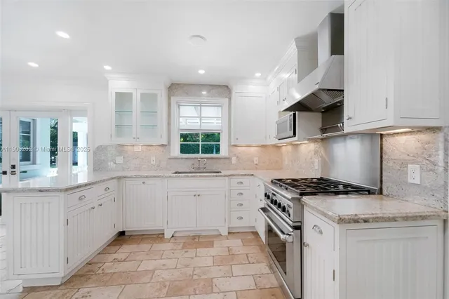a kitchen with stainless steel appliances granite countertop a sink and cabinets