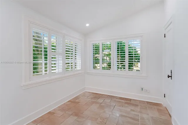 a view of wooden floor and a ceiling fan in a room