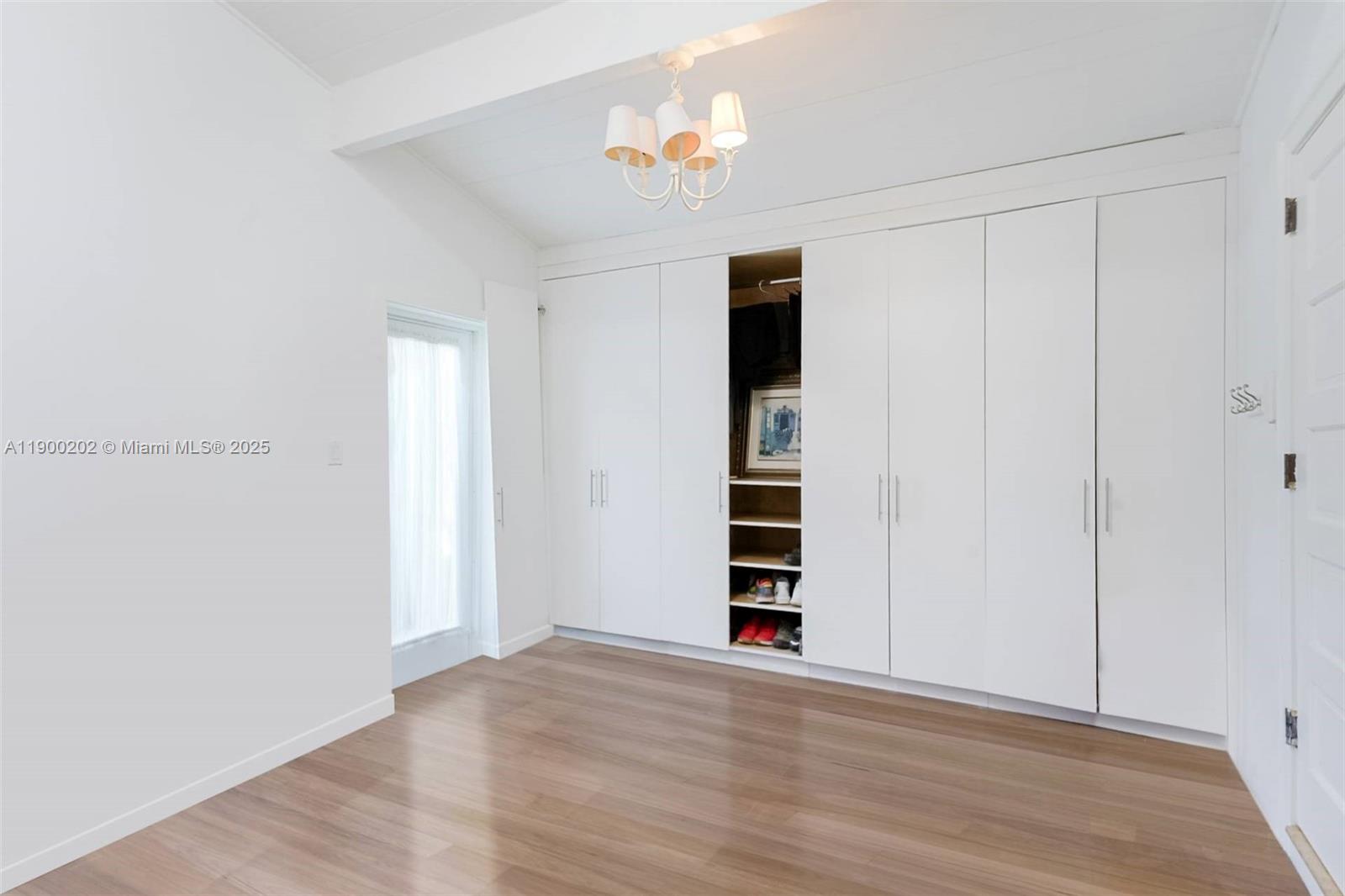4920 Southwest 76th Street Miami, FL 33143 - Photo 27 of 36 a view of wooden floor and a ceiling fan in a room