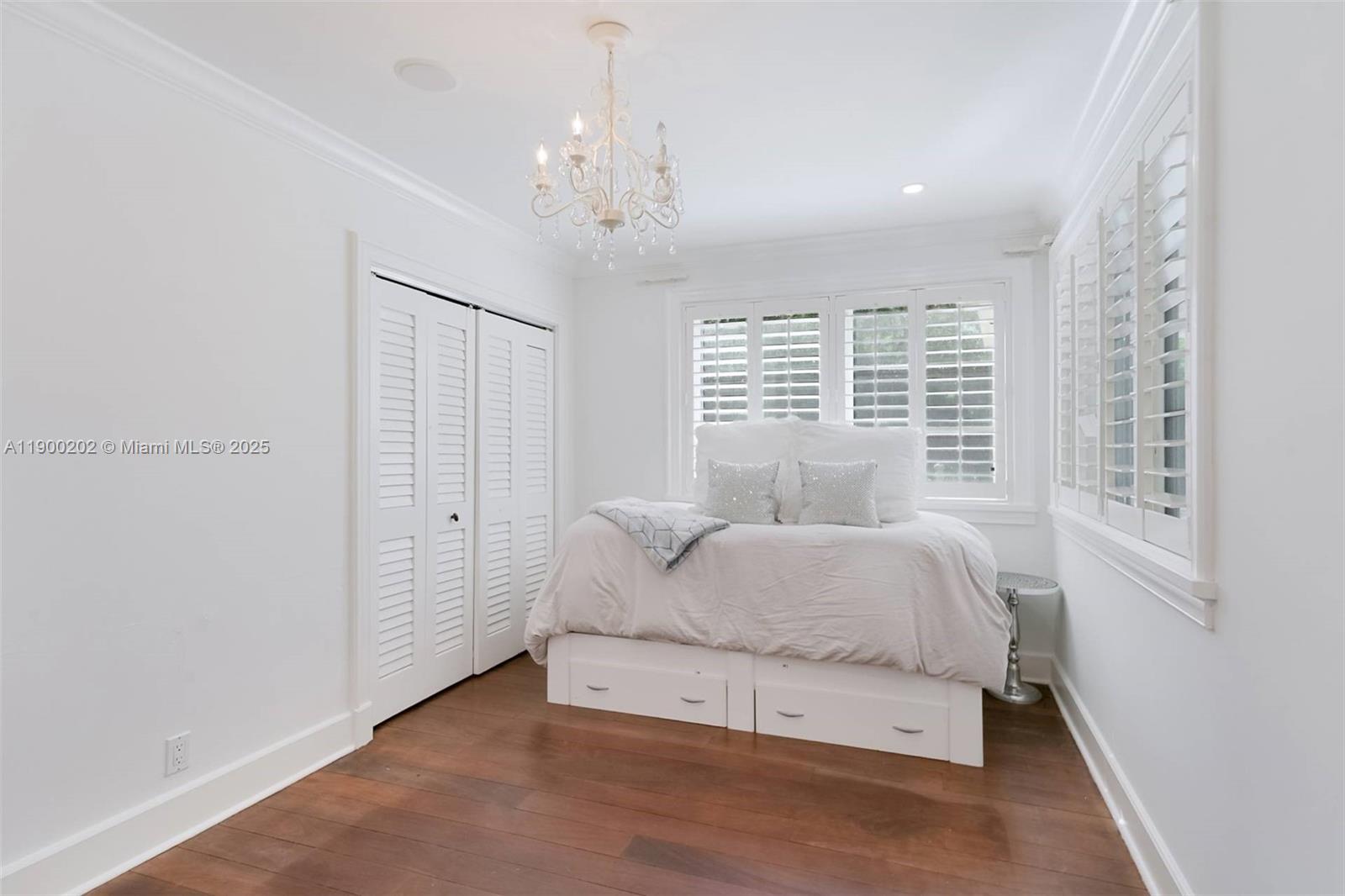 4920 Southwest 76th Street Miami, FL 33143 - Photo 28 of 36 a spacious bedroom with a bed and a window
