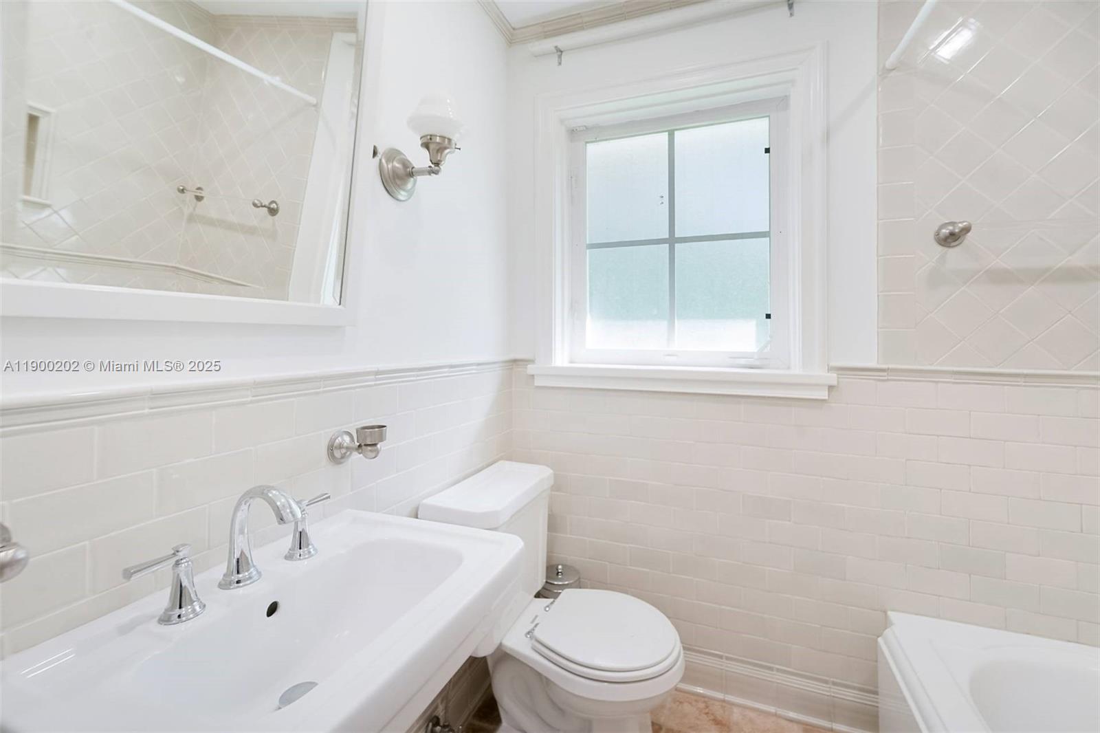 4920 Southwest 76th Street Miami, FL 33143 - Photo 32 of 36 a bathroom with a sink a toilet and shower