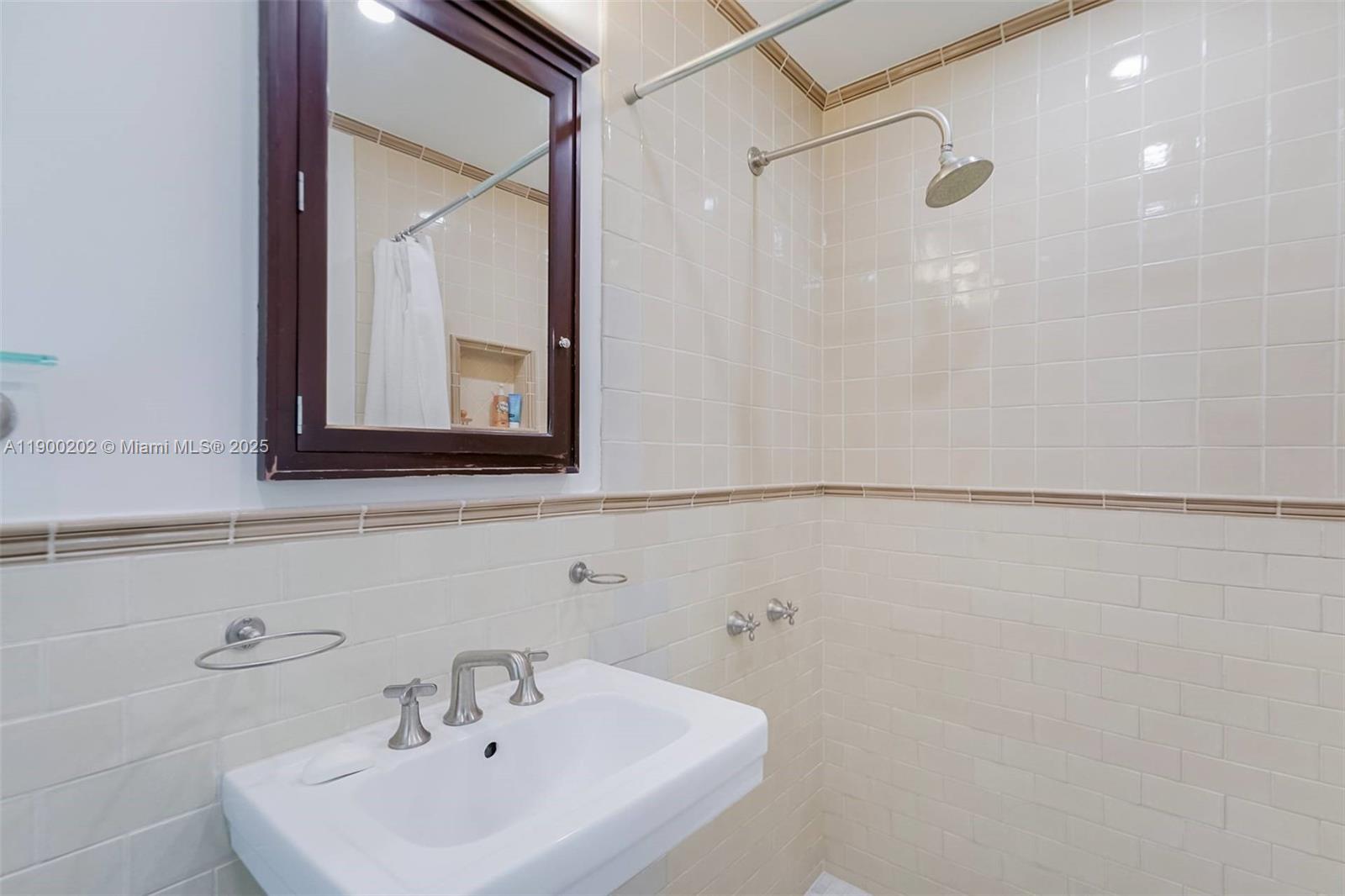 4920 Southwest 76th Street Miami, FL 33143 - Photo 33 of 36 a bathroom with a sink a mirror and a shower