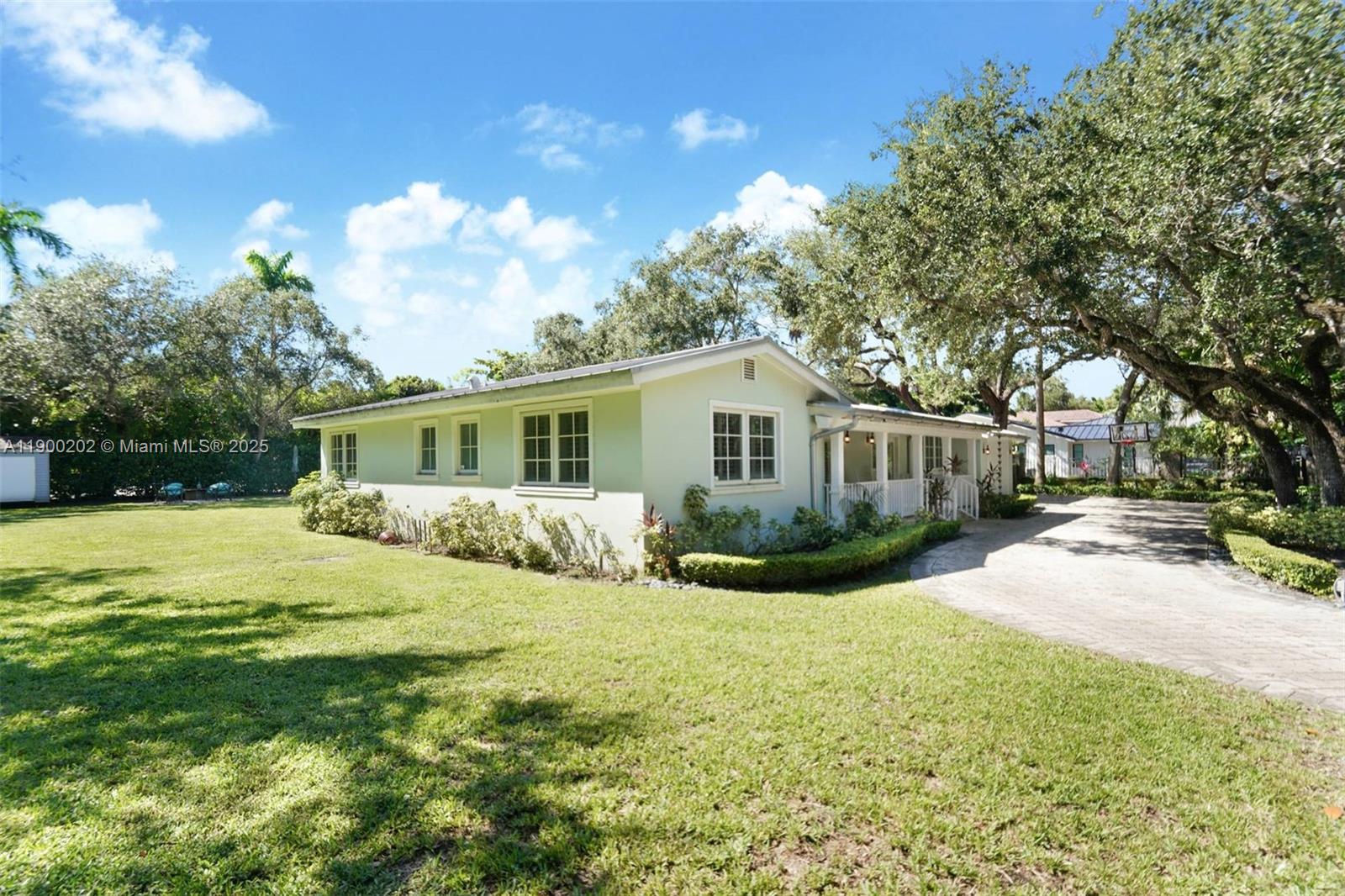 4920 Southwest 76th Street Miami, FL 33143 - Photo 4 of 36 a view of a house with a yard and chairs