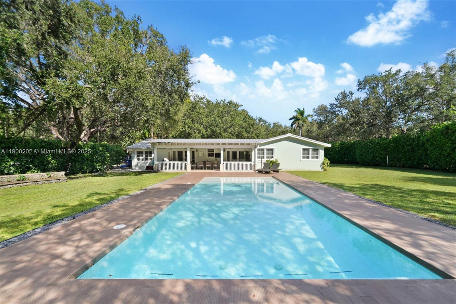 4920 Southwest 76th Street Miami, FL 33143 - Photo 6 of 36 a front view of a house with a yard