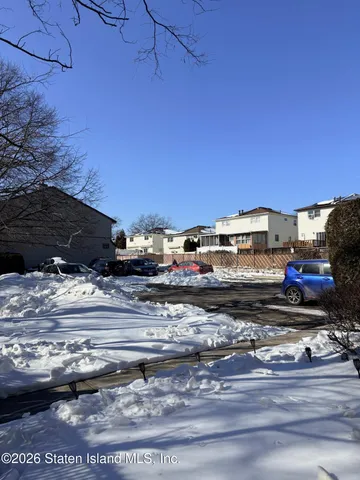 a view of a building with a car parked on the road