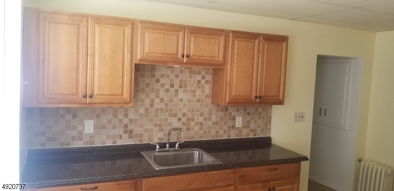 517 Woodlawn Avenue Linden, NJ 07036 - Photo 4 of 7 a close view of a sink and a cabinet in the kitchen
