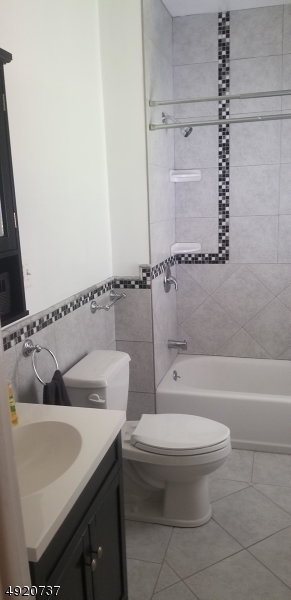 517 Woodlawn Avenue Linden, NJ 07036 - Photo 5 of 7 a bathroom with a toilet a sink and bathtub