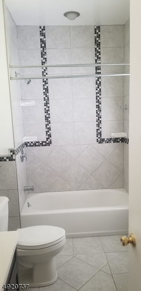 517 Woodlawn Avenue Linden, NJ 07036 - Photo 7 of 7 a bathroom with a toilet and a bathtub