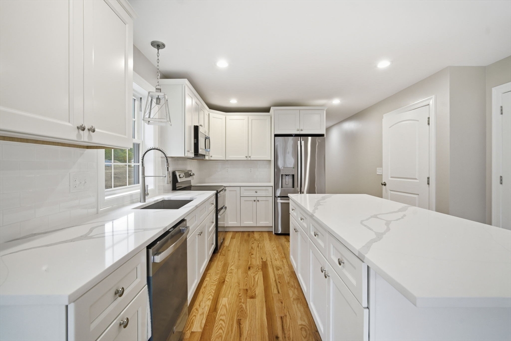 23 High Blf Road Belchertown, MA 01007 - Photo 14 of 39 a large kitchen with kitchen island a sink a stove and a refrigerator