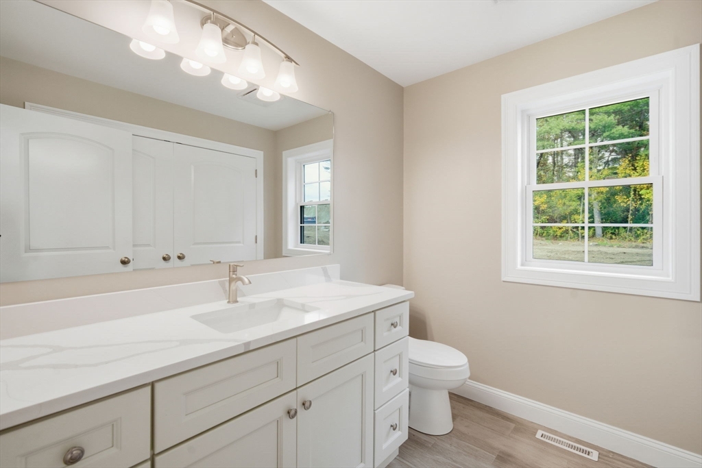 23 High Blf Road Belchertown, MA 01007 - Photo 16 of 39 a bathroom with a sink a toilet and a window