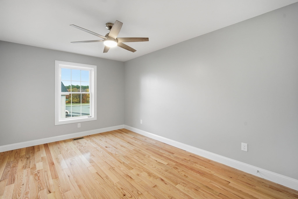 23 High Blf Road Belchertown, MA 01007 - Photo 22 of 39 a view of an empty room with wooden floor and a window