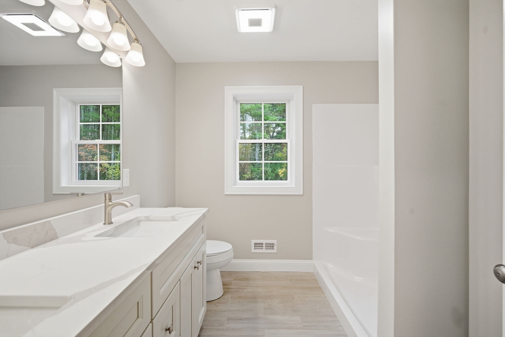 23 High Blf Road Belchertown, MA 01007 - Photo 30 of 39 a bathroom with a sink a toilet and a window