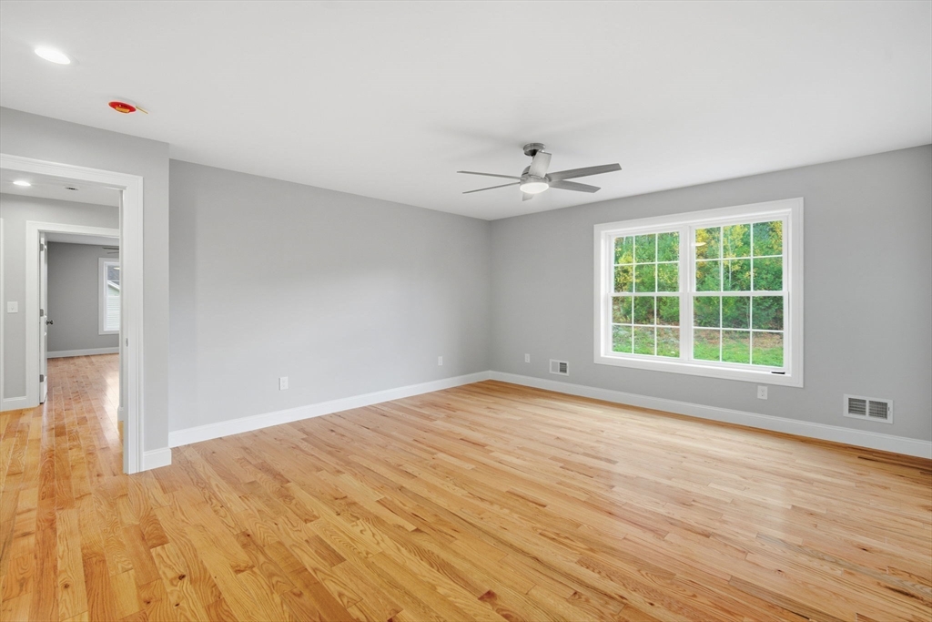 23 High Blf Road Belchertown, MA 01007 - Photo 32 of 39 a view of an empty room with wooden floor and a window