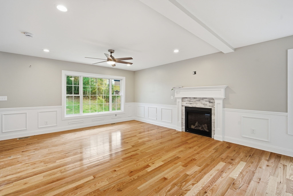 23 High Blf Road Belchertown, MA 01007 - Photo 6 of 39 a view of empty room with wooden floor and fireplace