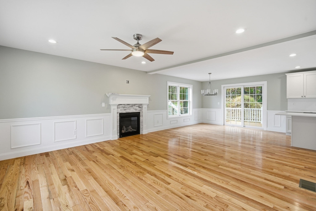 23 High Blf Road Belchertown, MA 01007 - Photo 7 of 39 a view of empty room with wooden floor and fireplace