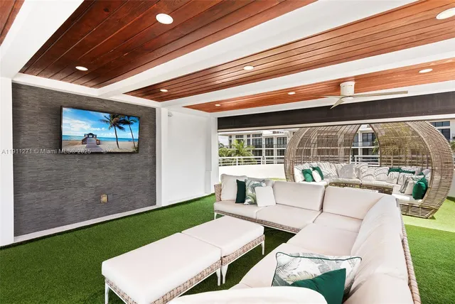 a living room filled with furniture hardwood floor and a ceiling fan