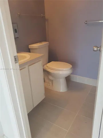 a white toilet sitting next to a sink