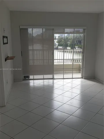a view of a livingroom with a floor to ceiling window and chandelier