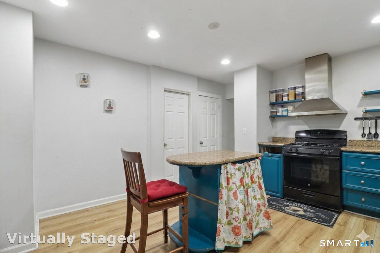 37 Manhan Street Waterbury, CT 06710 - Photo 3 of 19 a kitchen with stainless steel appliances granite countertop a stove a sink and a refrigerator
